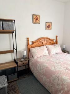 a bedroom with a bed and a book shelf at Casa Alora in Alora