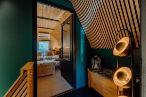 a bathroom with two urinals and a room with a bed at Maroska Pine in Kismaros