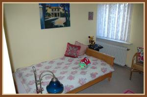 a small bedroom with a bed with a flower pattern at Panoramablick 85 m2 5 persoons in Lennestadt +10 photos