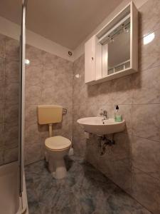 a bathroom with a toilet and a sink at Rose Zaglav in Zaglav