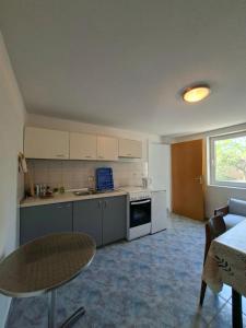 a small kitchen with a table and a table and a couch at Rose Zaglav in Zaglav