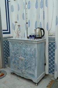a blue cabinet with a tea kettle on top of it at C 44 the local history in Jaipur