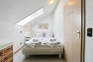 a bedroom with a bed with towels on it at Residenz Ostseestrand Appartement 29 in Scharbeutz +40 photos