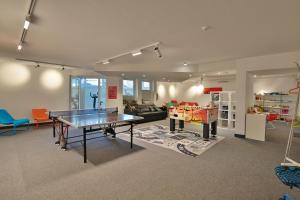 a living room with a ping pong table in it at Residenz Ostseestrand Appartement 29 in Scharbeutz