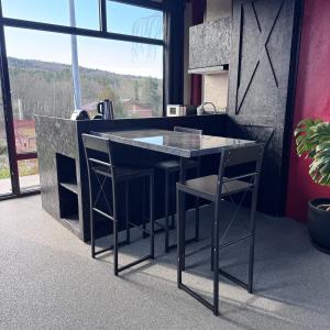 a kitchen with a counter with two chairs and a table at Baraka Suite in İznik
