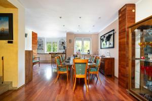a kitchen and dining room with a table and chairs at Spa & Grill Family Villa - No Parties Allowed in Warsaw