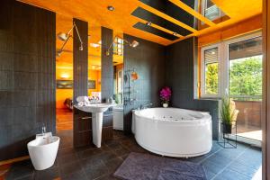 a bathroom with a large tub and a sink at Spa & Grill Family Villa - No Parties Allowed in Warsaw +15 photos