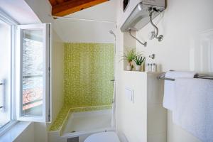 a bathroom with a shower and a toilet at Apartments Festum in Šibenik +39 photos