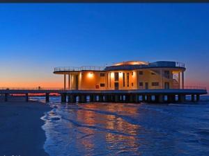 a building on a pier next to the water at Bouganvillea in Senigallia