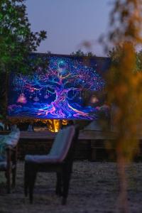 a large screen tv sitting on top of a bench at Mavi Kuş in Bektaş