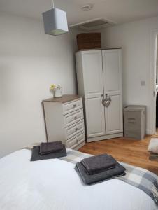 a bedroom with a white bed with two towels on it at Hillview in Royaloak