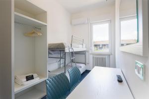 a small room with a table and bunk beds at CASA MAJOR Appartamenti in Cervia