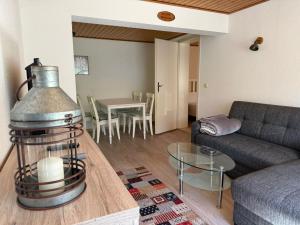a living room with a couch and a table at Gemütlicher Bungalow in Canow mit Terrasse, Hof und Seenähe in Wustrow