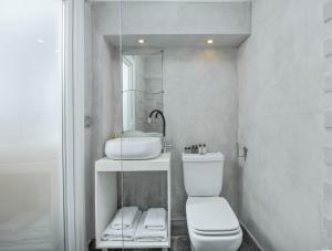 a white bathroom with a sink and a toilet at The Loft by Life Homes in Corfu