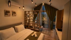 a bedroom with a bed and a large window at Azure Olive Collection in Ulcinj +127 photos