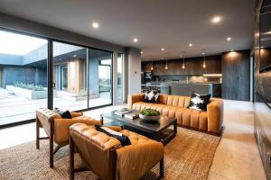 a large living room with couches and a table at Black C House Modern w pool spa in Yucca Valley