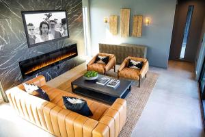 a living room with two couches and a fireplace at Black C House Modern w pool spa in Yucca Valley