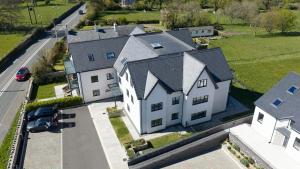 an aerial view of a large white house at Glynllifon 7 in Llanallgo