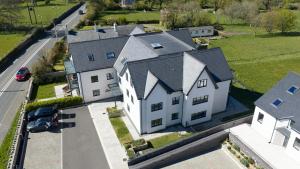an aerial view of a large white house at Glynllifon 5 in Llanallgo