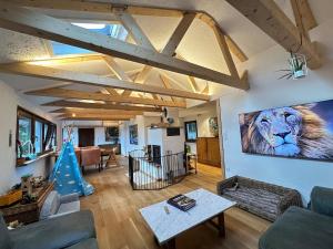 a living room with a painting of a lion on the wall at Nürburgring Eifelhaus in Baar