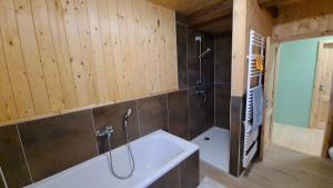 a bathroom with a shower and a bath tub at Wippertaler Hütte in Kleinfurra +11 photos