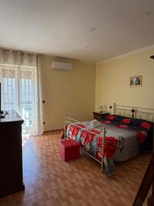 a bedroom with a bed and a large window at Da Raffaella affittacamere in Cicciano