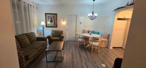 a living room with a couch and a table at Le Pirate Motel et Camping in Cap-Chat
