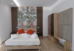a bedroom with a bed with two red pillows at Viroga Suite Apartments in Castel Volturno +95 photos