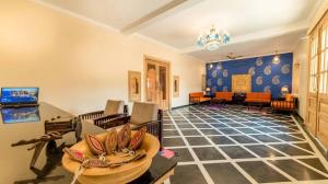 a living room filled with furniture and a chandelier at Golden Celestial haveli jaisalmer in Jaisalmer