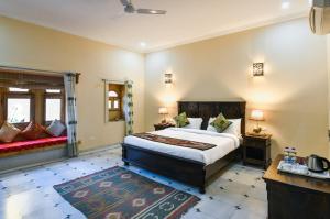 a bedroom with a large bed in a room at Golden Celestial haveli jaisalmer in Jaisalmer +110 photos