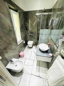 a bathroom with a toilet and a sink and a shower at Laura Rooms in La Spezia +9 photos