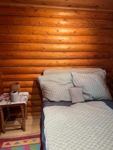 a bedroom with a bed and a wooden wall at See Paradies am Keltenberg in Wiesen