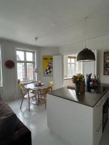 a kitchen and dining room with a table in it at Bright apartment in central Copenhagen in Copenhagen +7 photos