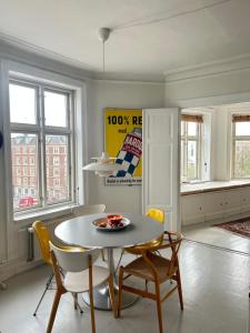 a dining room with a table and chairs at Bright apartment in central Copenhagen in Copenhagen
