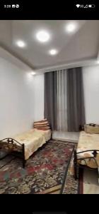 an empty room with two beds and a window at فيلا سالم الاشقر in Amman