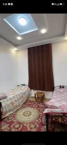 a room with a bed and a window and a rug at فيلا سالم الاشقر in Amman +2 photos