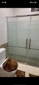 a bathroom with a toilet with a window at فيلا سالم الاشقر in Amman