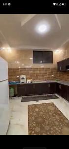 a kitchen with a black counter and a tv on the wall at فيلا سالم الاشقر in Amman