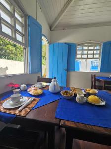 a table with plates of food on top of it at San Sebastian Taipu de Fora in Marau