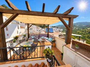 a balcony with a view of a city at Casa mi sùeño azul in Torrox