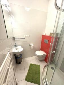 a bathroom with a toilet and a sink and a shower at Pikolo - izby na prenájom in Nové Mesto nad Váhom
