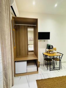 a room with a small table and a cupboard at Laura Rooms in La Spezia