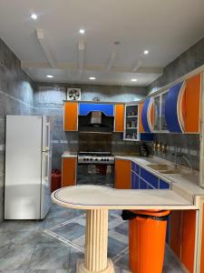 a kitchen with a table and a refrigerator at شالهيات ريست 2 in Hail