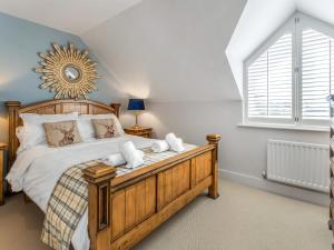 a bedroom with a large bed and a window at Smugglers Den in Beadnell
