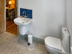 a bathroom with a sink and a toilet at Bailey Cottage in Staindrop