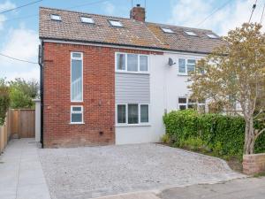 a brick and white house with a garage at Whit's End House in Whitstable +21 photos