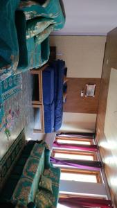 a room with a couch and a bunk bed at Rautelahomestay in Harsil