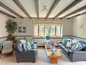 a living room with two couches and a table at Lambourne House - Ukc2831 in Skegness