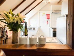 a kitchen with a counter with a vase of flowers at Hayloft-E2699 in Winthorpe