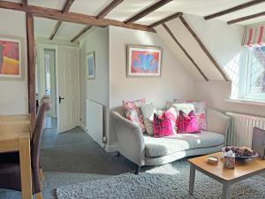 a living room with a couch and a table at Hayloft-E2699 in Winthorpe